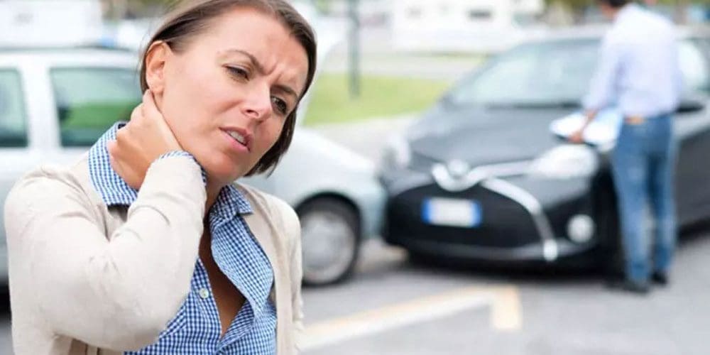 A woman is in pain after a car accident.