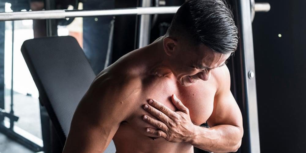 A man at the gym is suffering from a reaction injury.