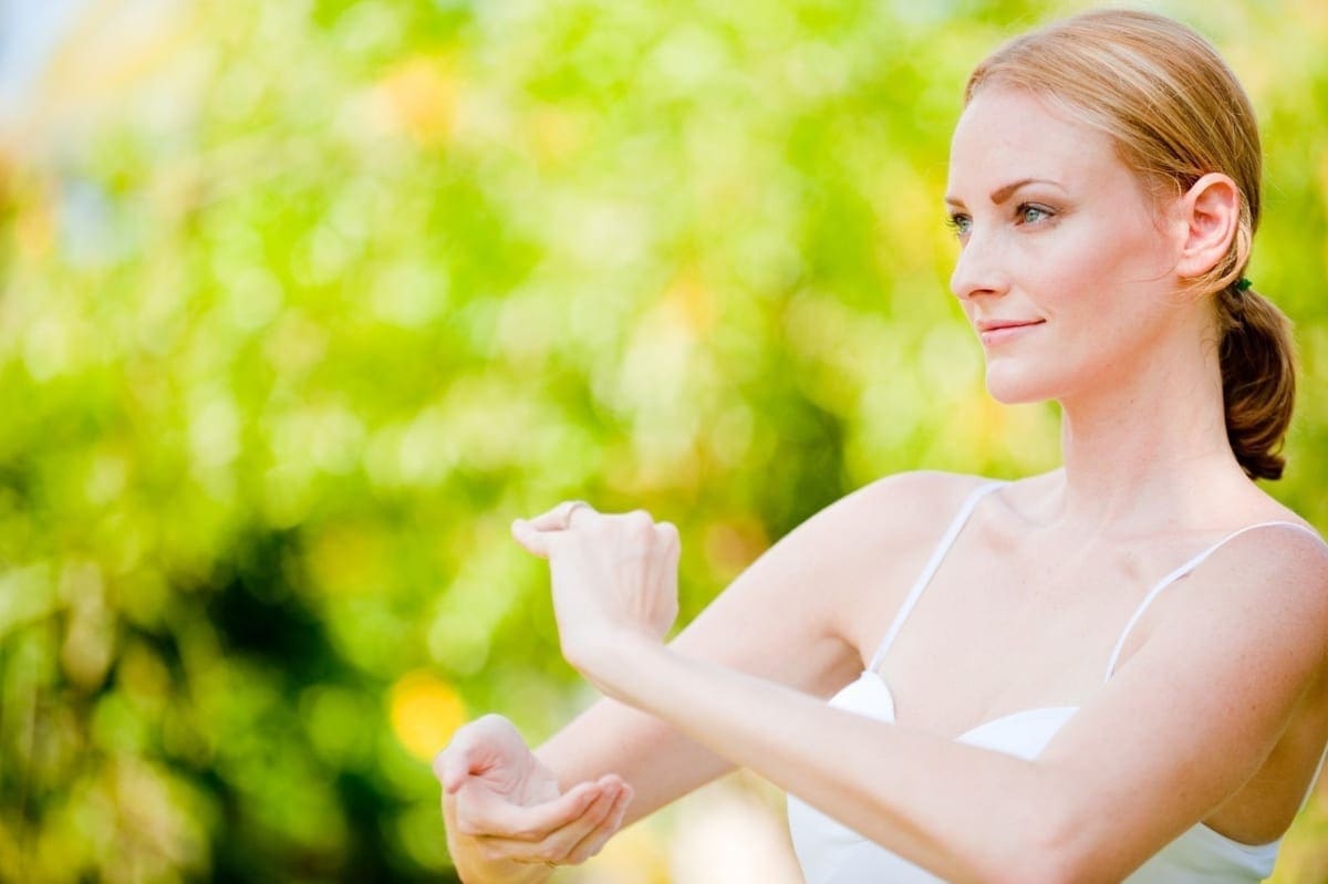 A woman looks serene as she practices tai chi.