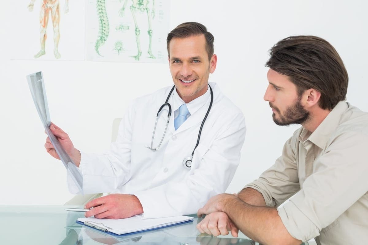 A chiropractor disuses treatment options with a patient.