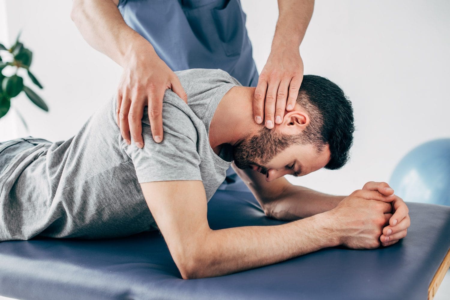 a man is being treated for whiplash at the Gresham Oregon Chiropractic clinic.