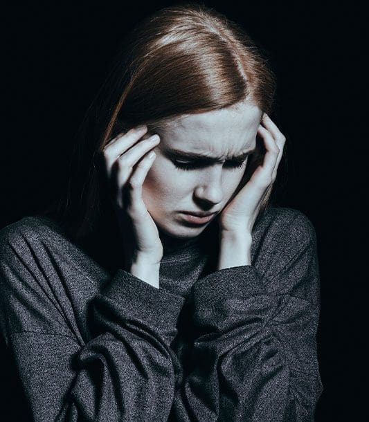 A woman looks distraught because she was diagnosed with a concussion.