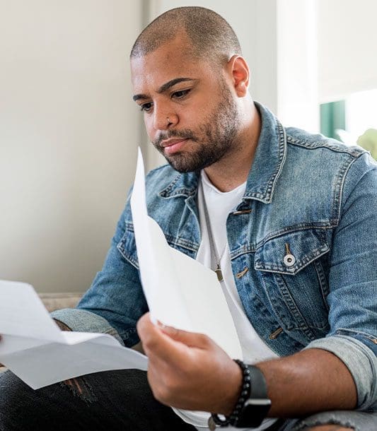 A man looks through insurance documents.