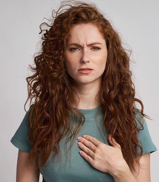 A young woman experiencing chest pain.