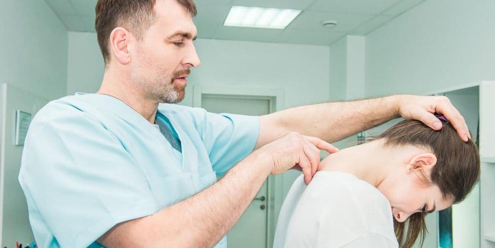 a doctor is examining a woman's spinal cord injury.