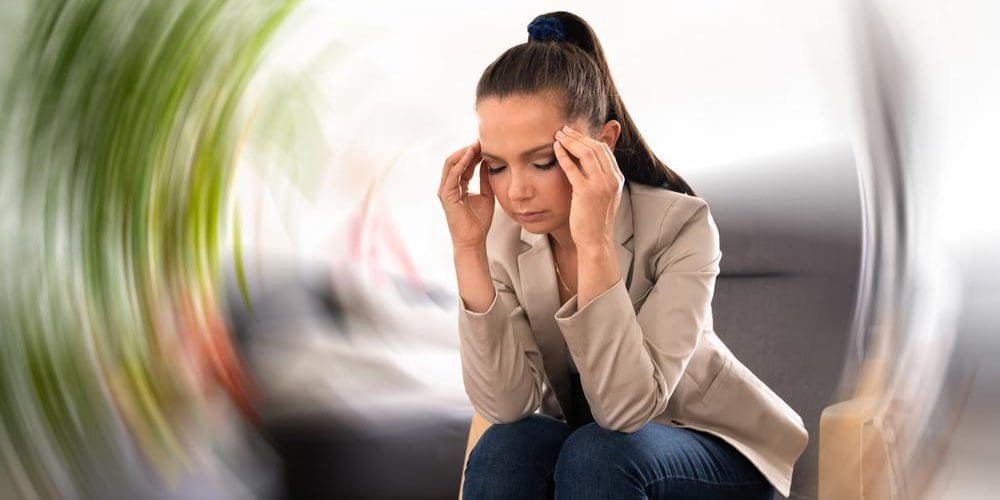 A woman is suffering from vertigo.