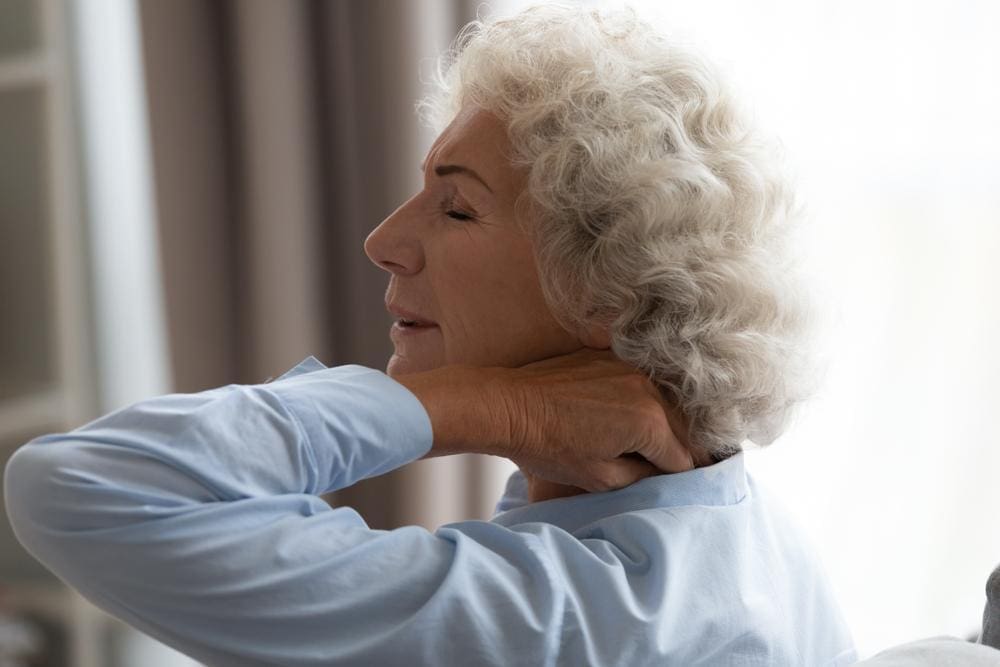 A woman is in pain from Osteoarthritis.