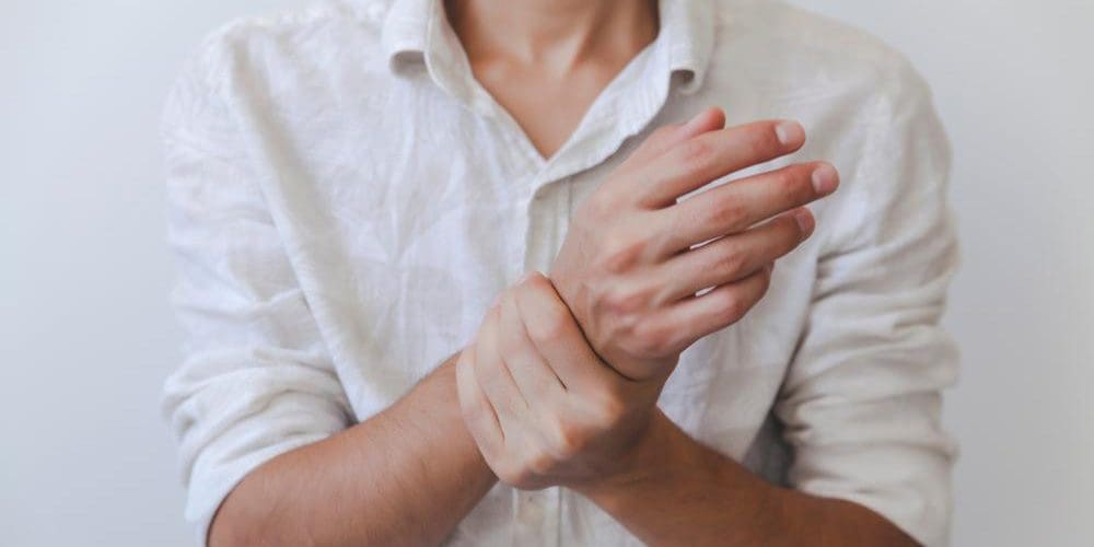 A man is experiencing numbness and tingling in this arms and hands. b