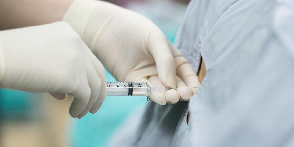 A woman is getting an epidural injection.