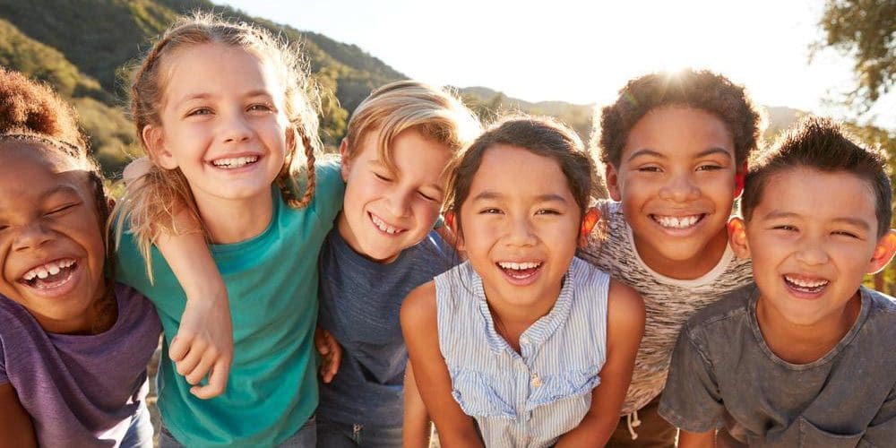 A group of happy healthy children smiling.