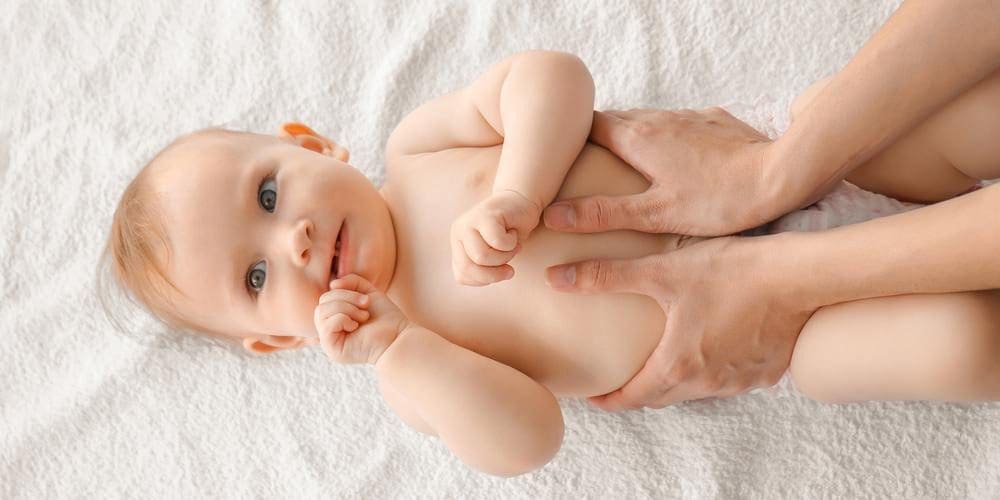 A baby is getting chiropractic treatment.