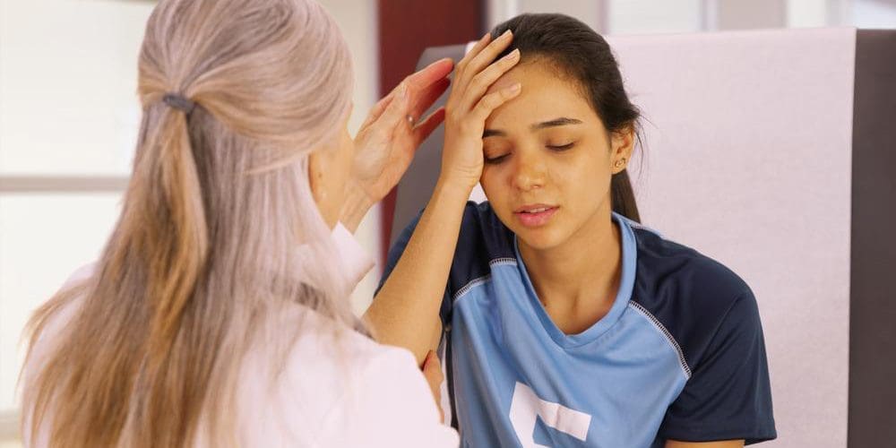 A girl is suffering from symptoms of a concussion.