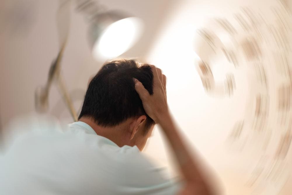 A man is suffering from concussion symptoms.