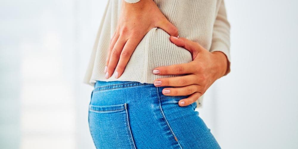 A woman is struggling because of hip flexor pain.