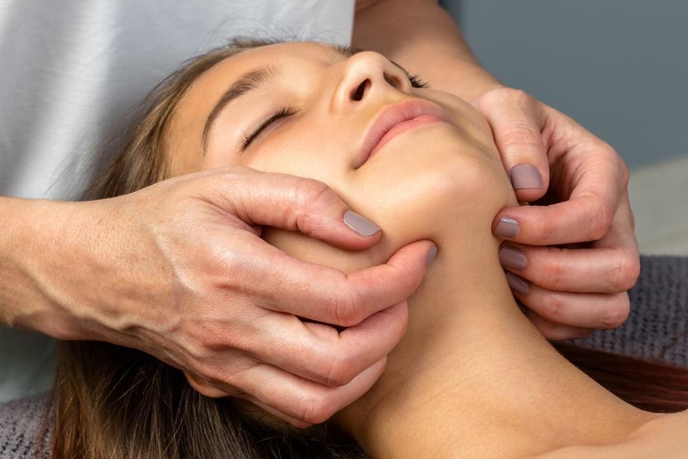 A chiropractic adjustment is easing a womans trigeminal neuralgia pain.