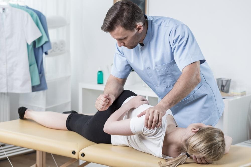A woman is getting a chiropractic adjustment. 