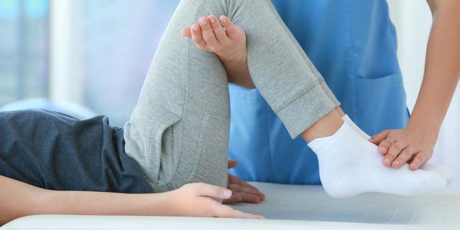 A woman is getting lower body chiropractic adjustment.