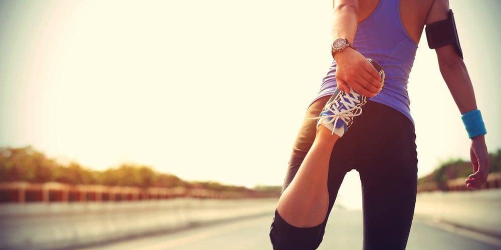 A woman is stretching to improve mobility and flexibility.