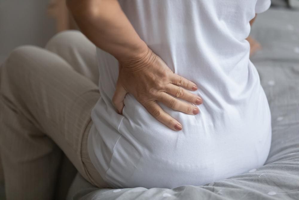 a woman is struggling with stomach pain. 