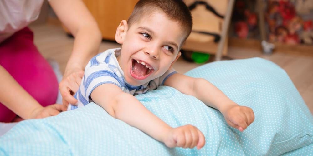 A young happy boy with cerebral palsy.