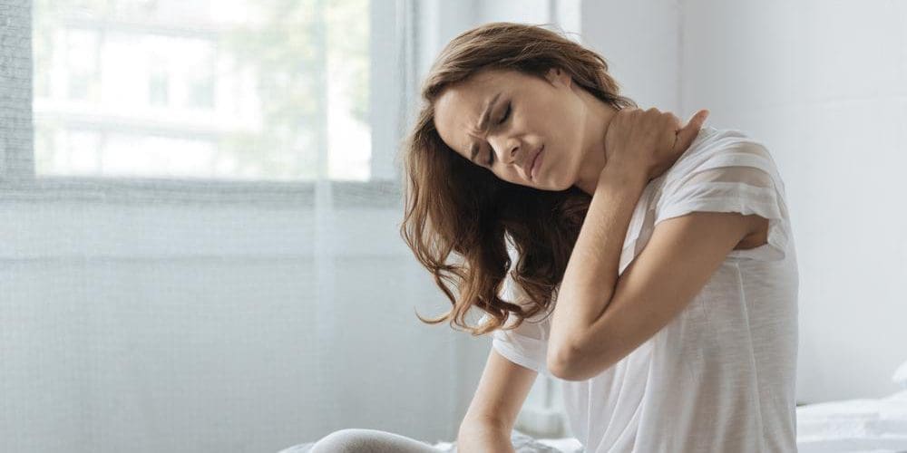 A woman is suffering from arthritis in her neck.