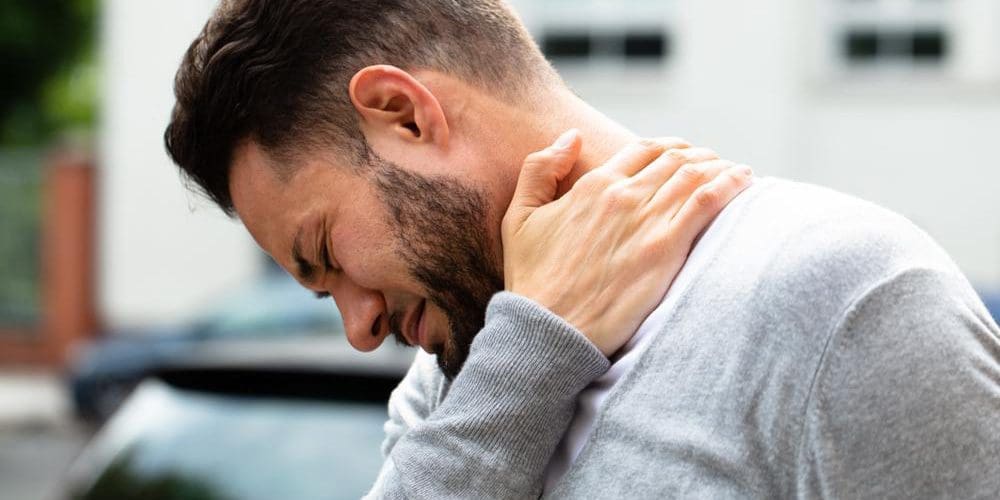 A young man is in pain because of cervical radiculopathy.