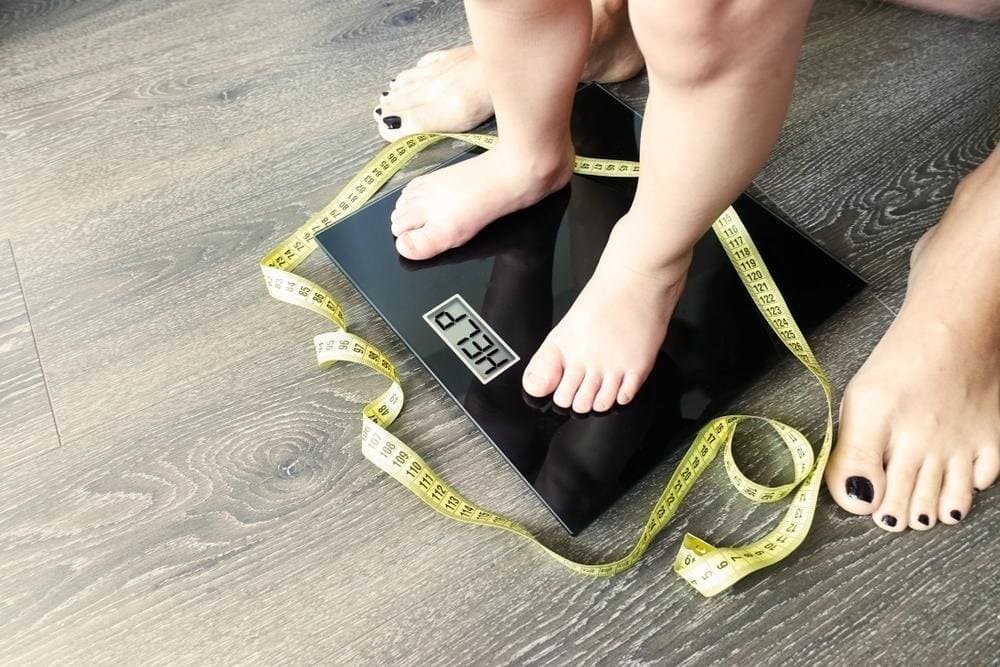 A child is standing on a scale.