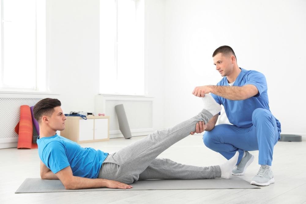 A chiropractor is treating a man with bone spurs. 