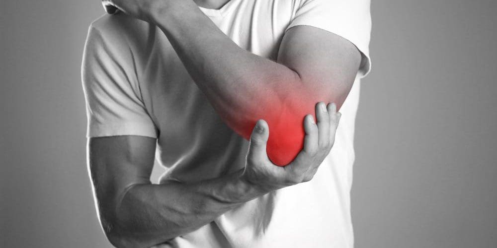 A man is suffering from tendonitis in his elbow.