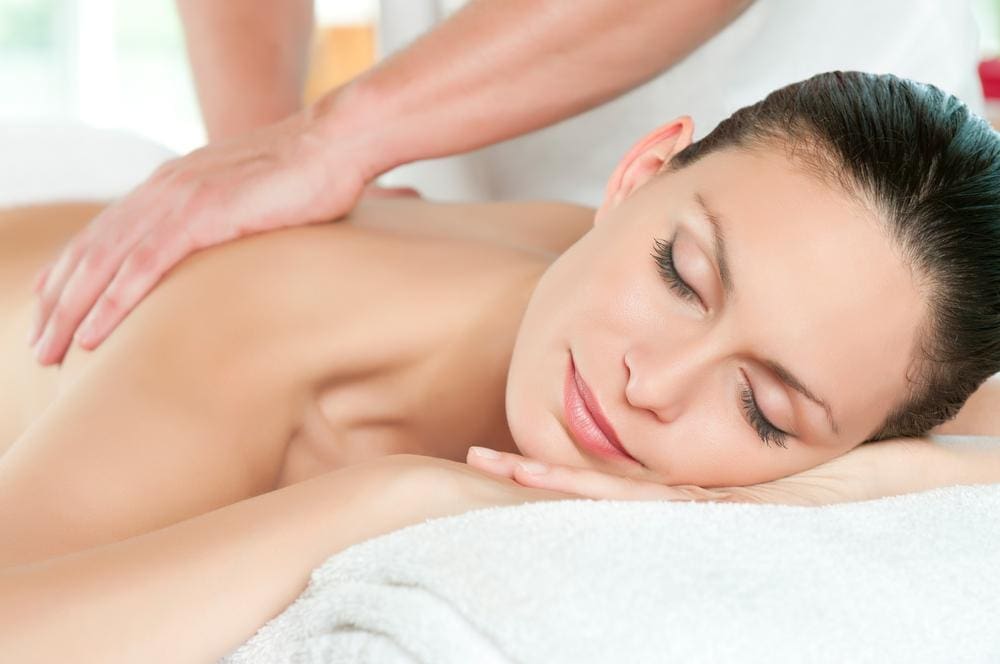 A woman is getting a therapeutic massage to ease pain from her degenerative disc disease.
