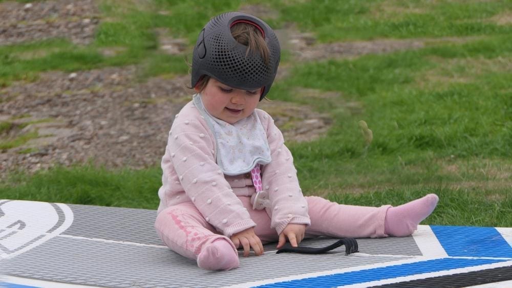 A baby us wearing a cranial remodeling helmet. 