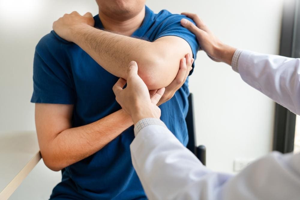 A man is getting a chiropractic adjustment to help manage Lupus symptoms. 