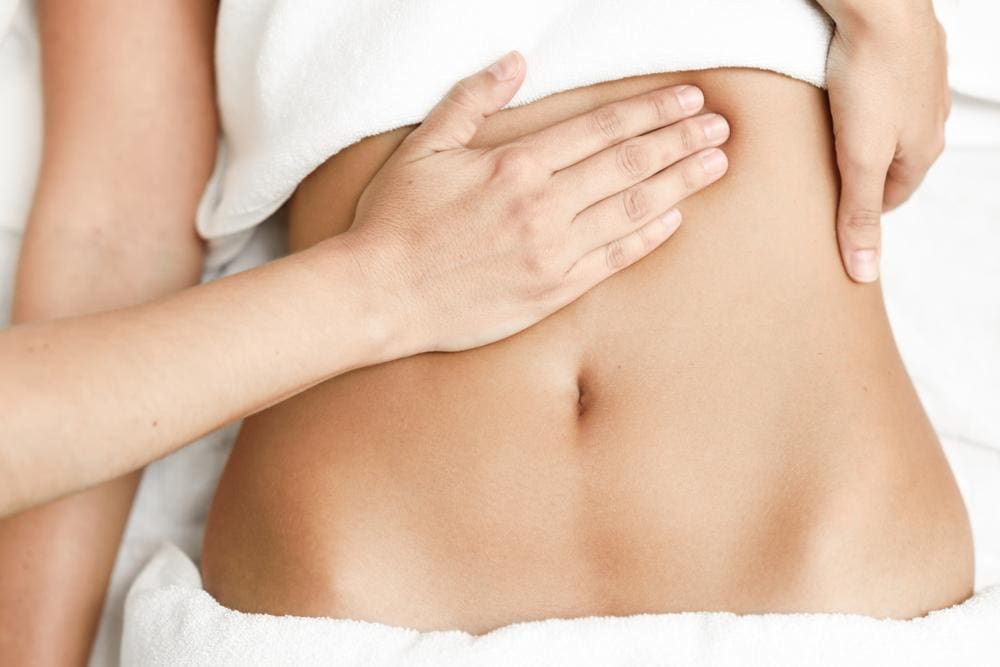 A woman is getting a therapeutic massage for a hiatal hernia.