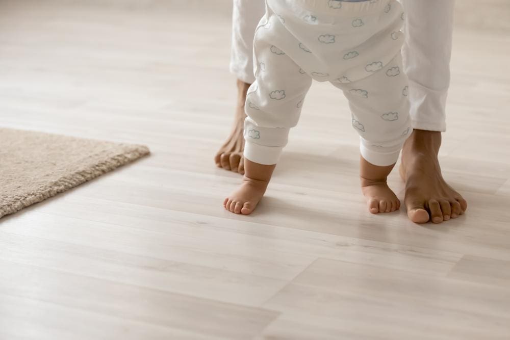 A mother helping her baby walk.