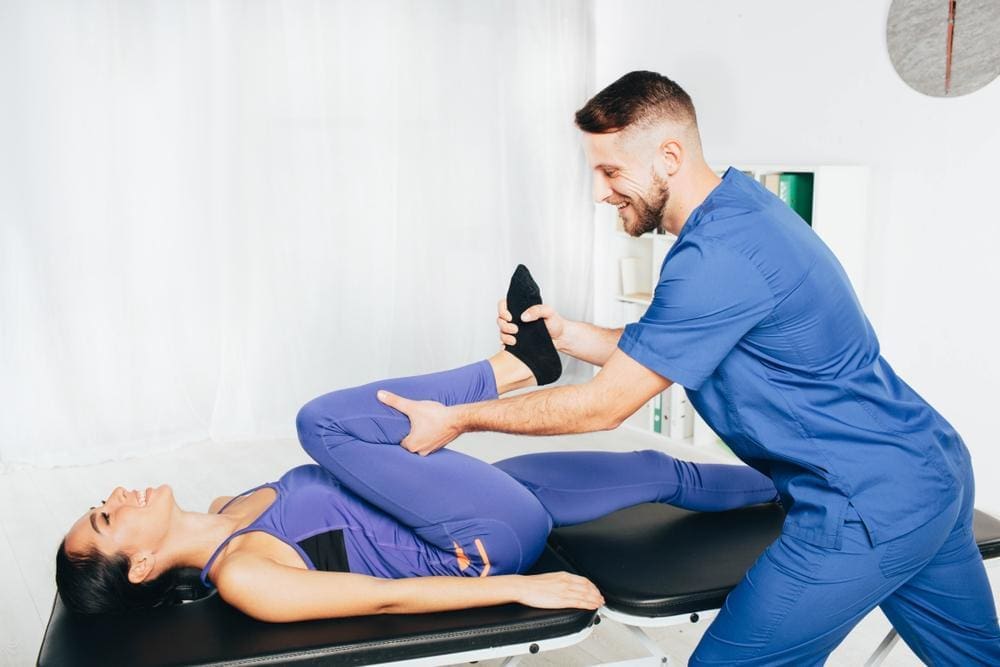 Woman receiving treatment for hip arthritis by a chiropractor.