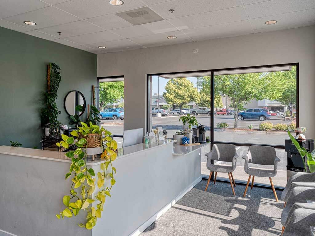 Front desk and waiting area at Accident Care Bend Chiropractic Clinic.