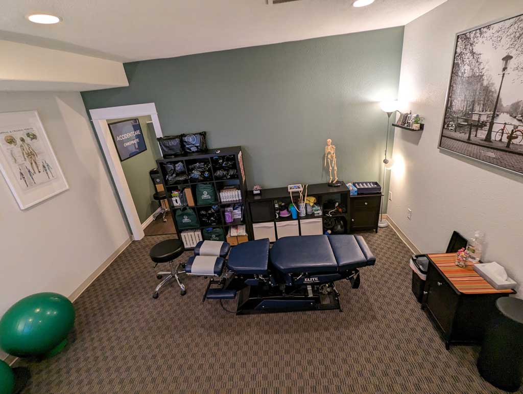 Gresham Clinic treatment room with chiropractor table.