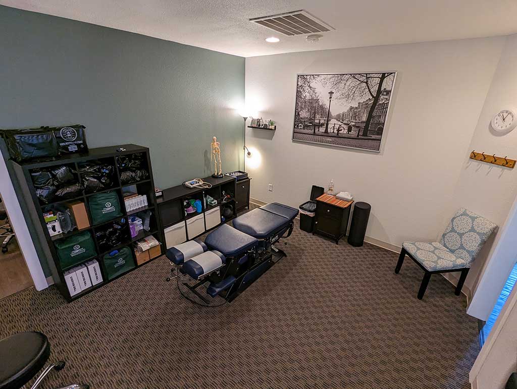 Alternate angle of the Gresham Clinic treatment room with chiropractor table.