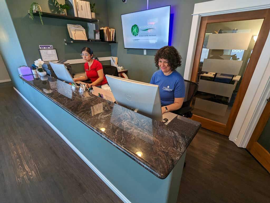 Closer view of Wide angle of front desk with workers at Gresham Chiropractor Clinic.