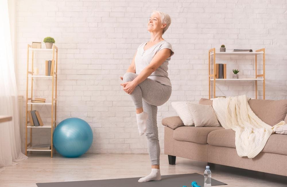 Older woman doing stretches at home