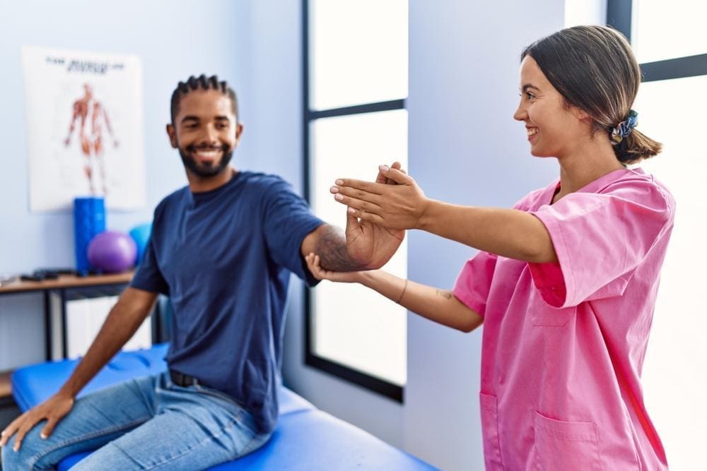 A chiropractor is treating a man for cmc joint pain.