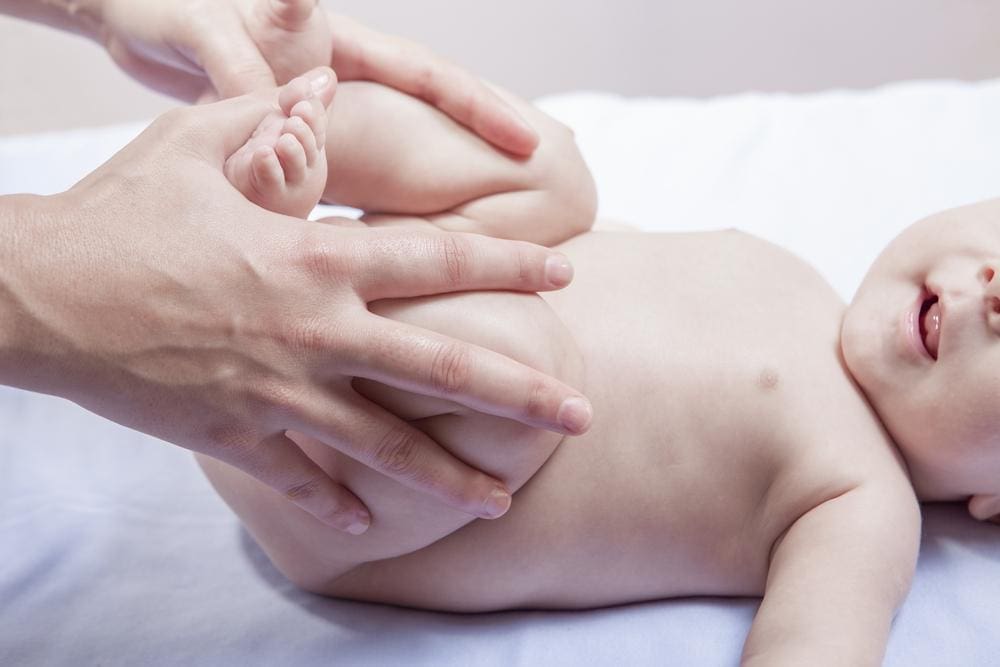Baby with legs pulled in to torso.
