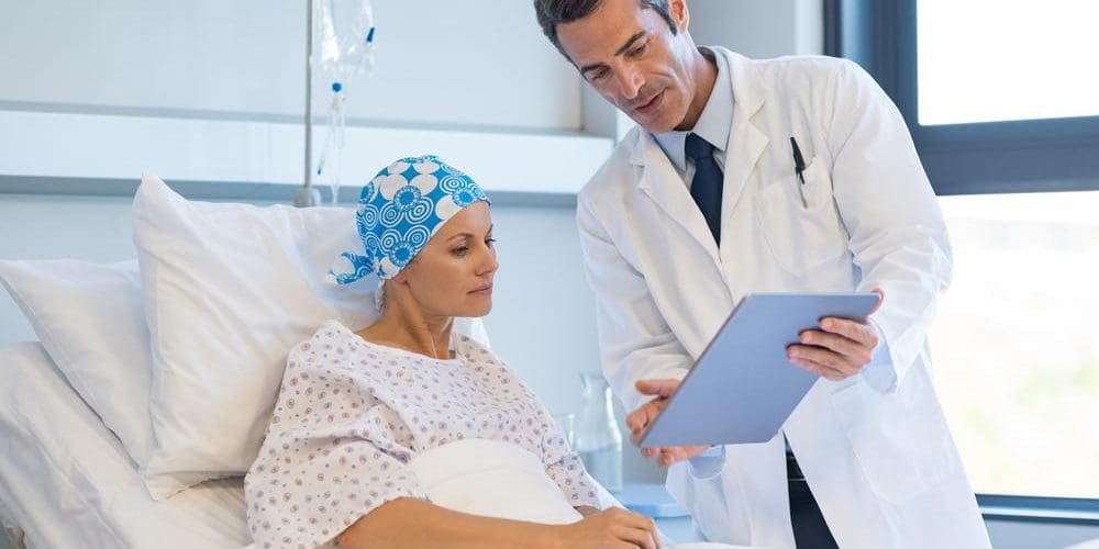 Doctor discussing medical test results with cancer patient.