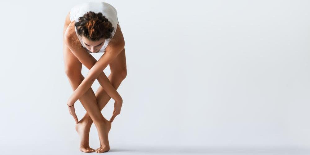 Young female dancer poses in a studio.