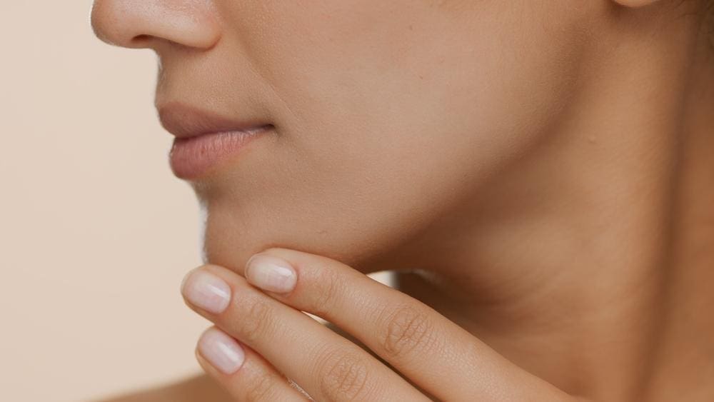 Close-up of a young woman's jaw.
