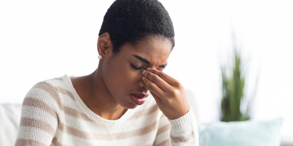 Young woman with sinus pain.