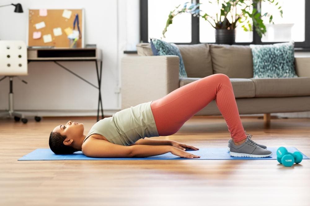 Young woman doing pelvic floor exercises.