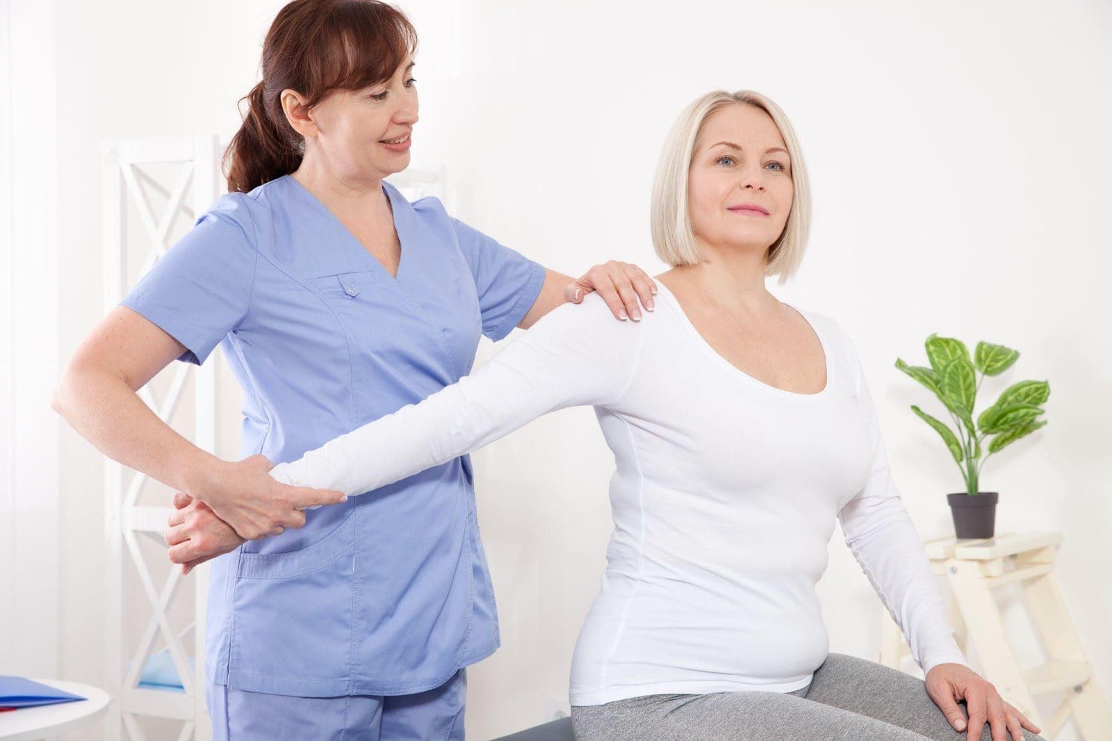 Middle-aged woman having shoulder adjustment.