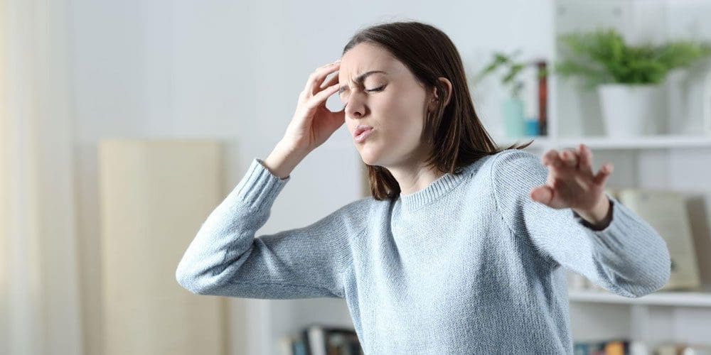Young woman experiencing Vasovagal syncope fainting.