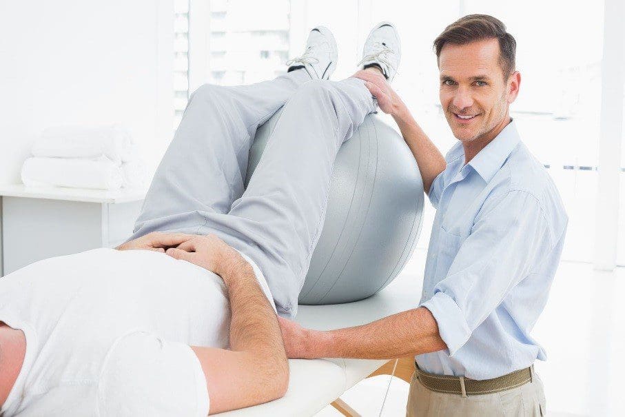 A Chiropractor is Conducting a Physical Therapy Session on His Patient.